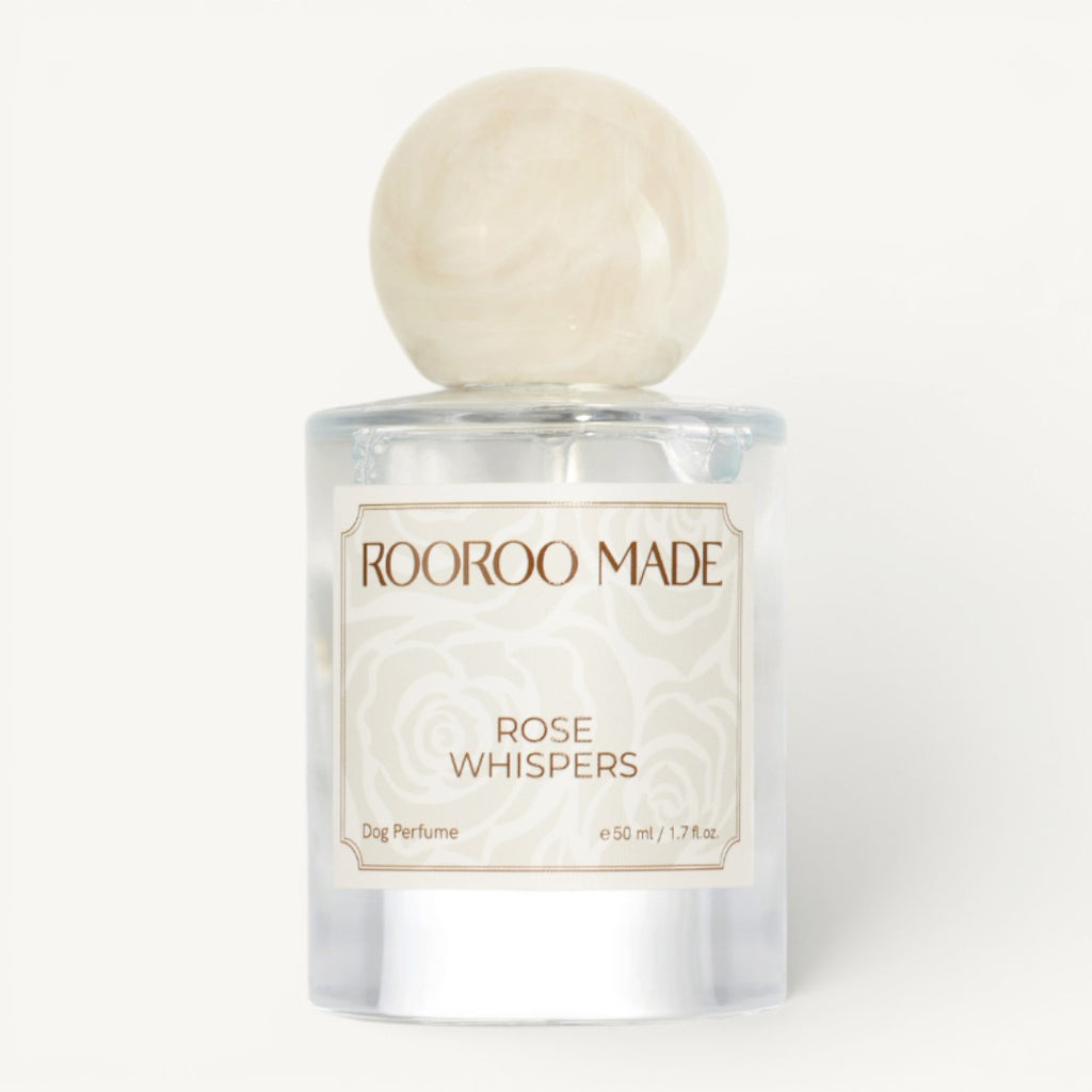 Dog perfume bottle labeled 'Rose Whispers' by Rooroo Made on a white background