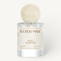 Dog perfume bottle labeled 'Rose Whispers' by Rooroo Made on a white background
