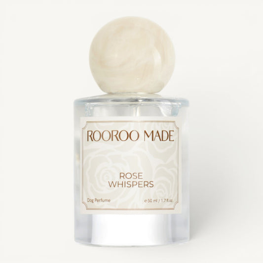 Dog perfume bottle labeled 'Rose Whispers' by Rooroo Made on a white background