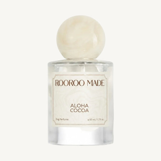 The Scented Canine Aloha Coco dog perfume in a 50ml glass bottle with a round marble-effect cap.