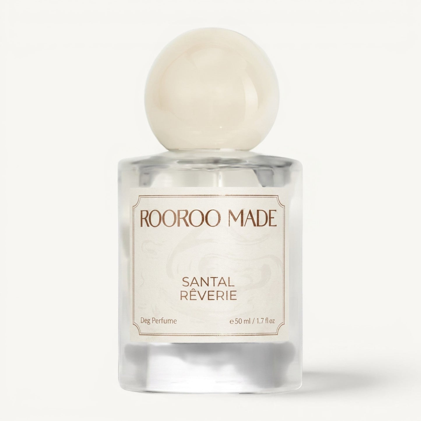 The Scented Canine Santal Rêverie luxury dog perfume in a clear glass bottle with a round cream cap.