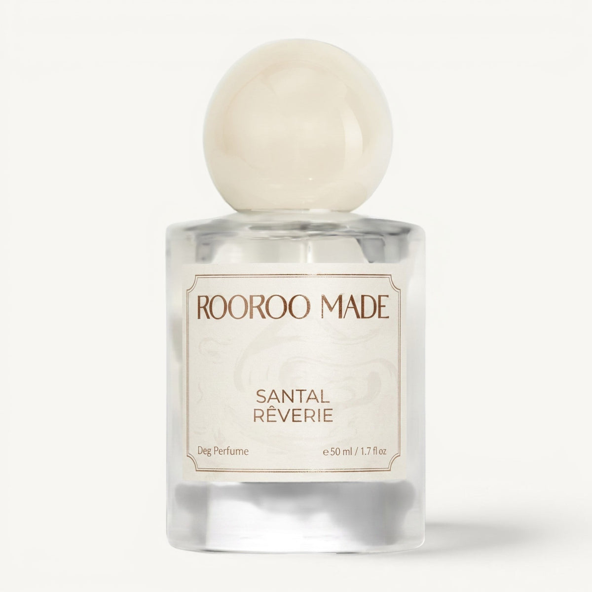 The Scented Canine Santal Rêverie luxury dog perfume in a clear glass bottle with a round cream cap.