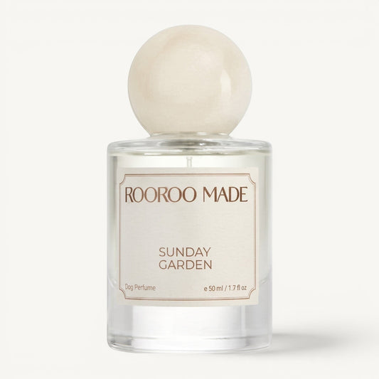 The Scented Canine Sunday Garden luxury dog perfume in a clear 50ml glass bottle with a round cream-colored cap.